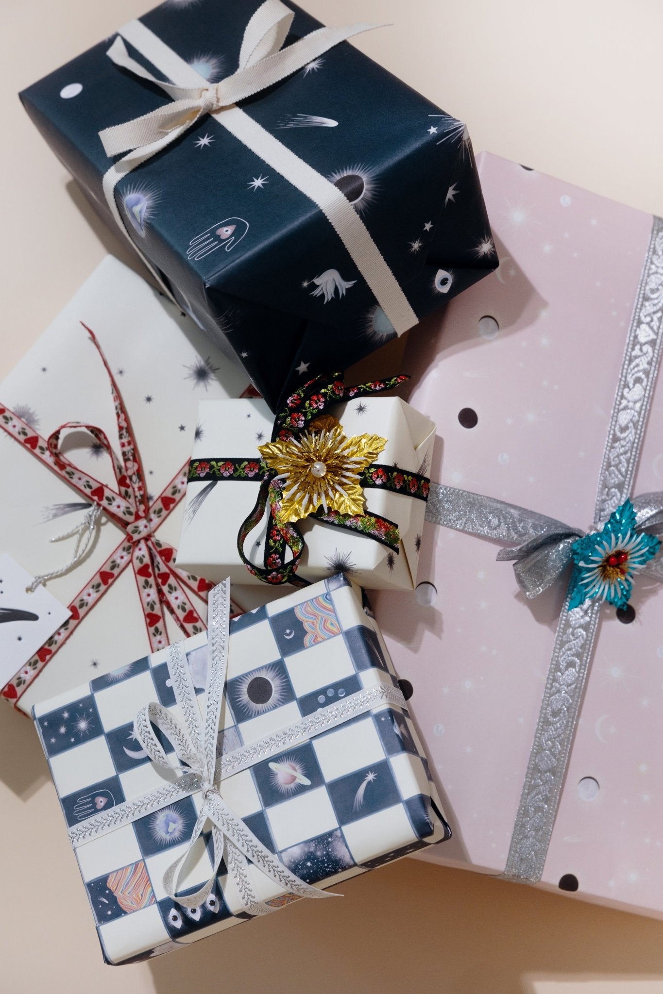 A pile of presents wrapped in assorted Adelfi gift wrap.