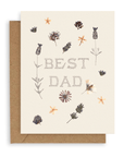 Cream colored card with scattered pressed flowers and the words "Best Dad" in pointillism style font. Shown with kraft envelope.