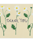  Three stems of lively white forest flowers cover the card nearly top to bottom horizontally, with the words "Thank You" going through the center of them in black ink. This design is printed on a cream colored background. 
