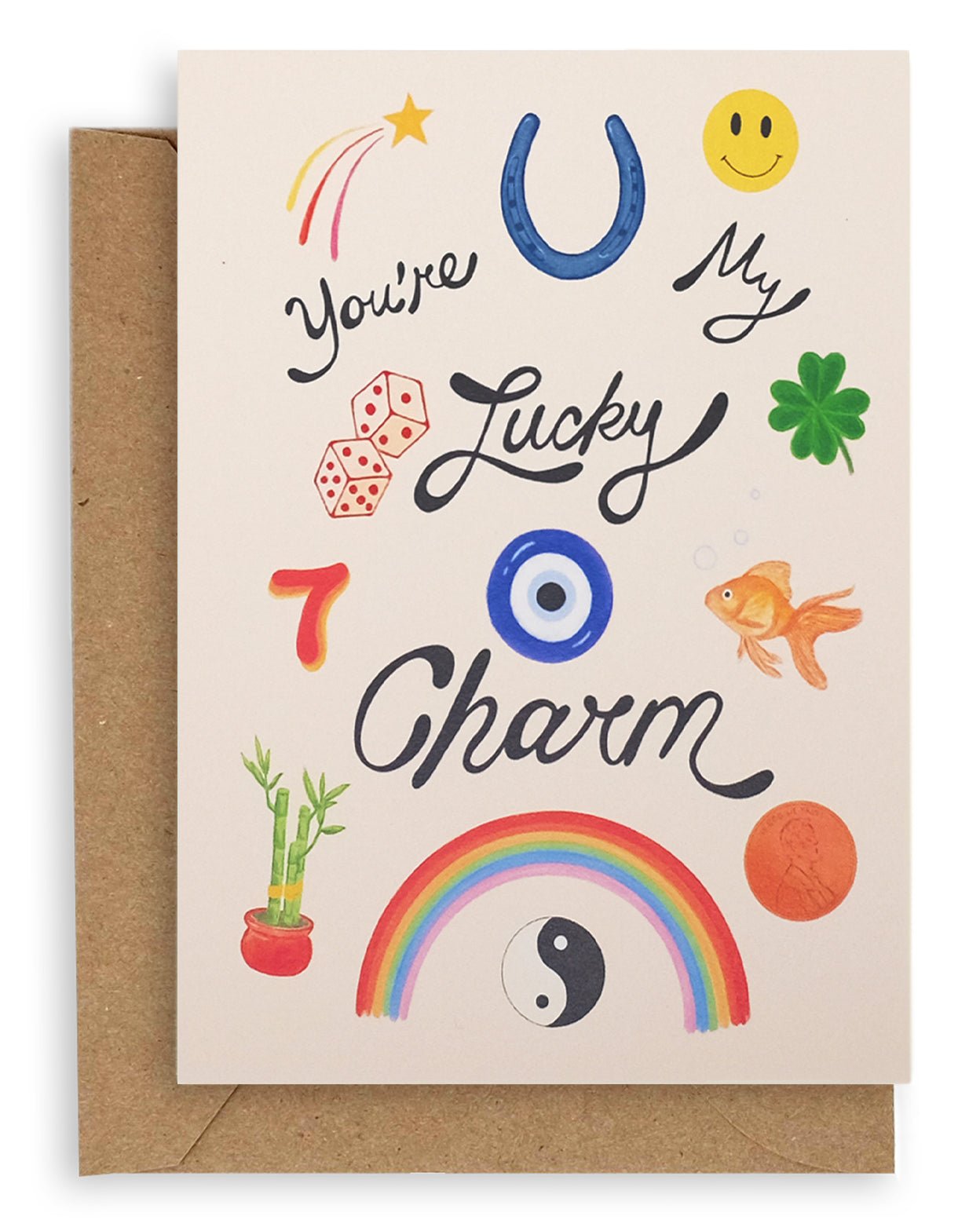 Cream colored card with various lucky items on the front: penny, goldfish, four leaf clover, dice, the number seven, bamboo plant, yin and yang, rainbow, horseshoe, shooting star, and smiley face with the words "You're My Lucky Charm" printed on cardstock. Shown with kraft envelope.