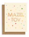 Rainbow colored stars surround the words "Mazel Tov" in multi-colored font printed on a cream background. Shown with kraft envelope.