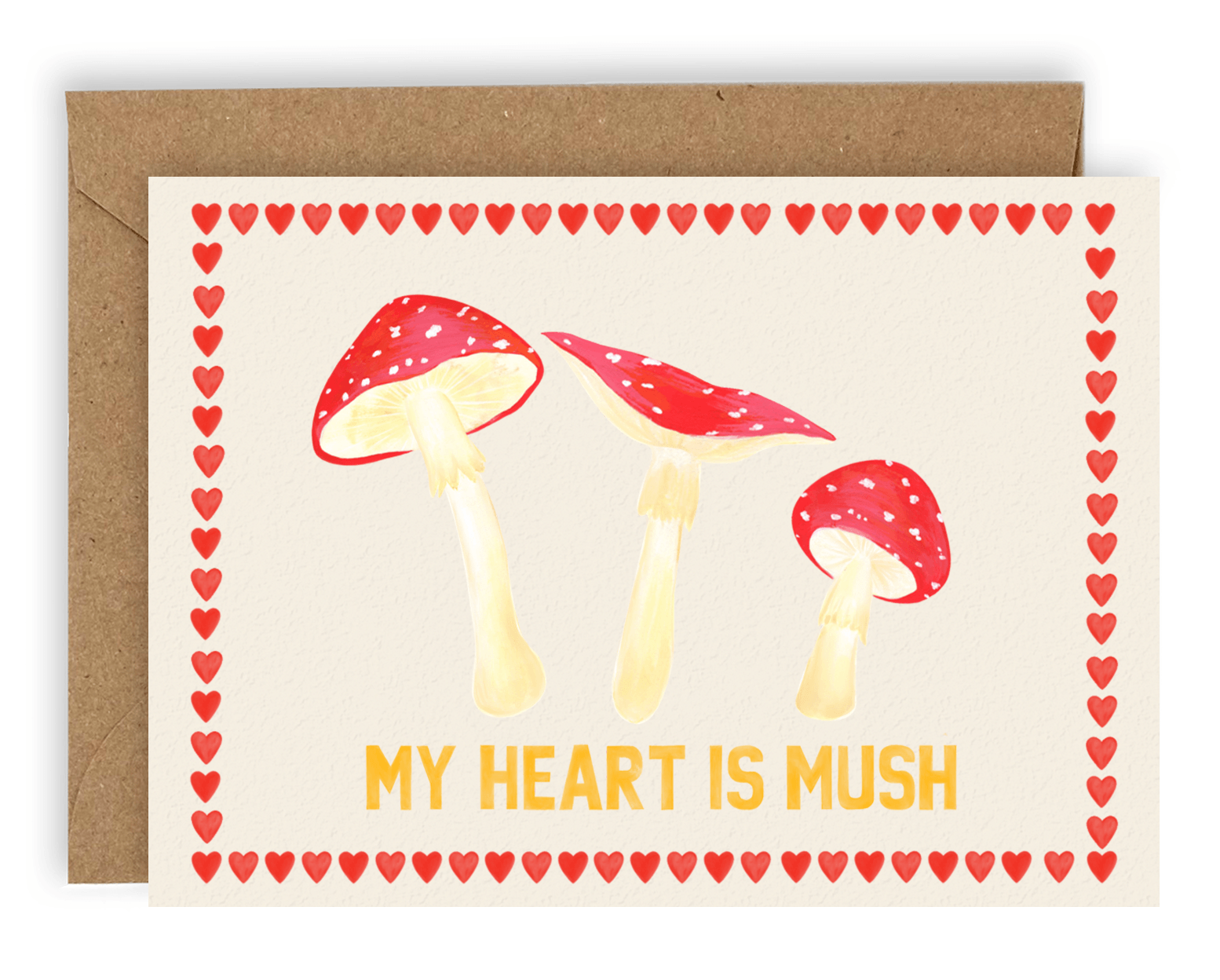 Three red mushrooms arranged above the words "my heart is mush" in orange font with red hearts stacked along every side of the card. Printed on a cream background. Shown with kraft envelope. 