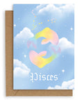 Pisces  Horoscope card with a kraft envelope. The horoscope symbol is painted in rainbow pastel on a blue background with white clouds.