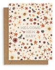 "Welcome New Baby" pointillism font design with tightly spaced pressed flowers on a cream colored background printed on cardstock with a kraft envelope.