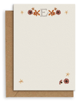 Adelfi monogram "E" notecard with kraft envelopes on a white background.