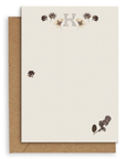 Adelfi monogram "K" notecard with kraft envelopes on a white background.