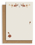 Adelfi monogram "V" notecard with kraft envelopes on a white background.