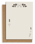 Adelfi monogram "W" notecard with kraft envelopes on a white background.