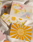 Four Love Notes cards on a white silk background.