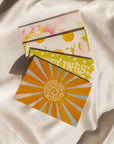 Four Love Notes cards on a white silk background.