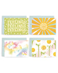 Four Adelfi cards with light blue envelopes: 1) green background with daisies and the word "feelings" three times, 2) "You are my sunshine" in a sun, 3) "You're so dreamy" in rainbow watercolored hearts, 4) "I'd pick you every time" in the center of a white daisy.