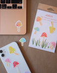 Magic mushroom sticker pack by iPhone and Macbook on kraft paper.
