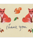  Our new Forest Creatures design with two red/orange foxes facing away from each other with an orange squirrel between them facing left with an Acorn in its hands. Below are the words "Thank You" printed in cursive black ink with two stems of Acorns on either side and a stem of an acorn above. Printed on a cream colored background.