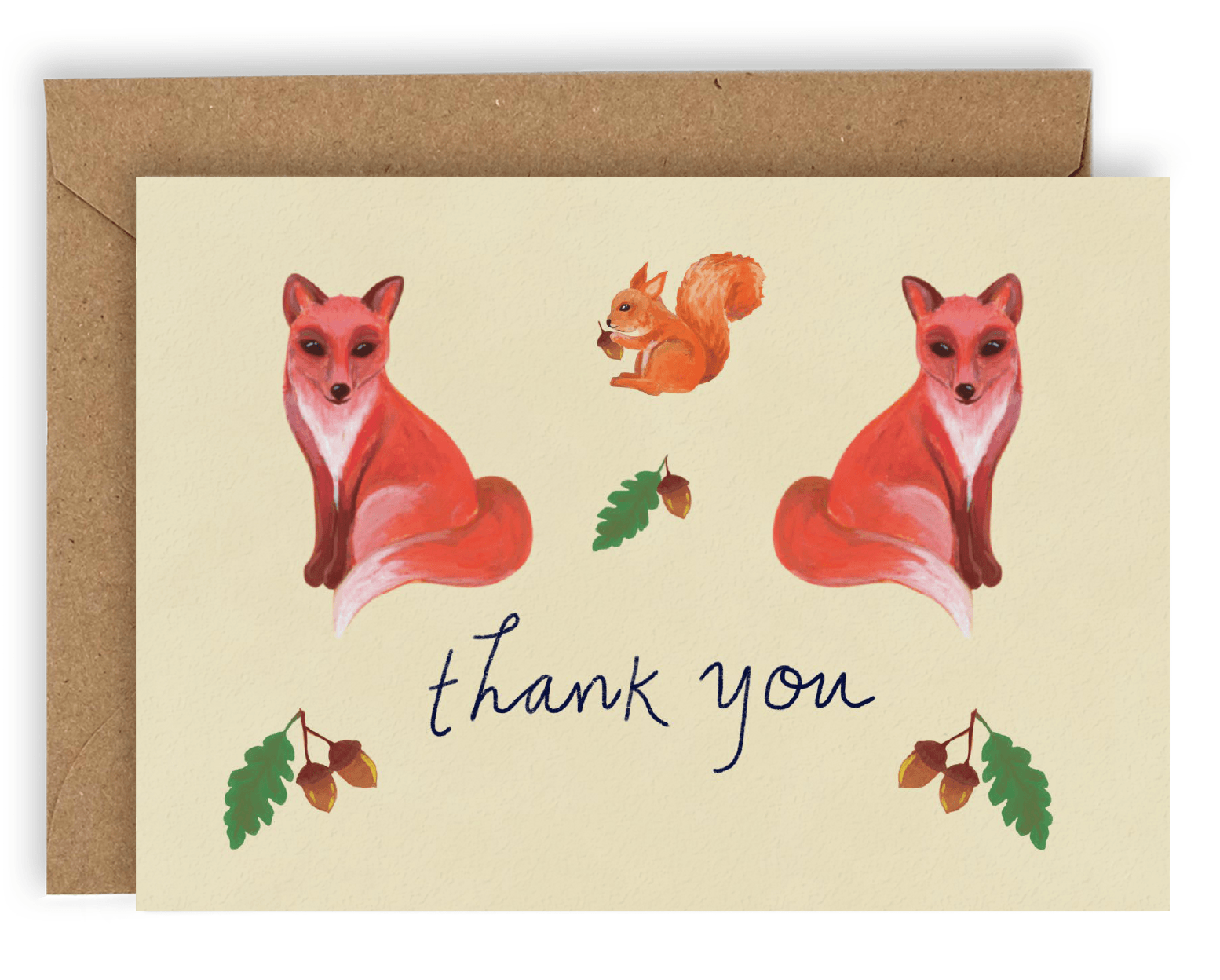 Our new Forest Creatures design with two red/orange foxes facing away from each other with an orange squirrel between them facing left with an Acorn in its hands. Below are the words &quot;Thank You&quot; printed in cursive black ink with two stems of Acorns on either side and a stem of an acorn above. Printed on a cream colored background. Shown With Kraft envelope.