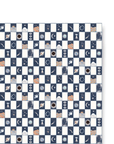 A sheet of gift wrap with a navy blue and cream checkerboard pattern. The navy boxes are filled with mystical icons. 