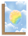 Leo  Horoscope card with a kraft envelope. The horoscope symbol is painted in rainbow pastel on a blue background with white clouds. 