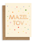 Rainbow colored stars surround the words "Mazel Tov" in multi-colored font printed on a cream background. Shown with kraft envelope. 