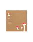 This gift tag features red magic mushrooms of varying height aligned diagonally in the upper left and lower right hand corners, with the words "To" and "From" in cursive all-caps font aligned center left. 