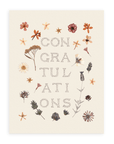 Front view of the "Congratulations" card with pressed flowers against a white background.
