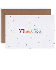 Rainbow stars thank you card. Rainbow colored letters printed on white cardstock with rainbow colored little stars spaced sparingly resting on a kraft envelope.