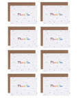 Several rainbow stars thank you cards with rainbow colored letters printed a white cardstock background resting on a kraft envelope.