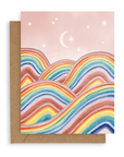 Landscape card with pink sky, moon, stars and rainbow mountains. Shown with kraft envelope. 