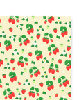 Our Strawberry holiday gift wrap features red strawberries on a stem of two or three, surrounded by smaller and larger red or green strawberries and white flowers printed on a cream colored background.