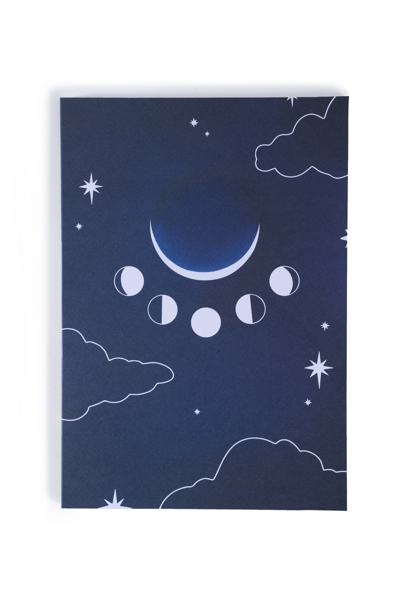 An Adelfi original journal design set in a dark blue night sky with cloud outlines, stars, and moon phases. Behind the journal is a white background.